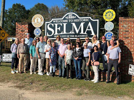 congregants in front of historic selma sign
